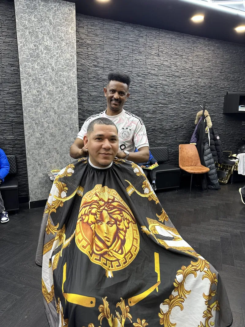 Our barber with a client in the salon